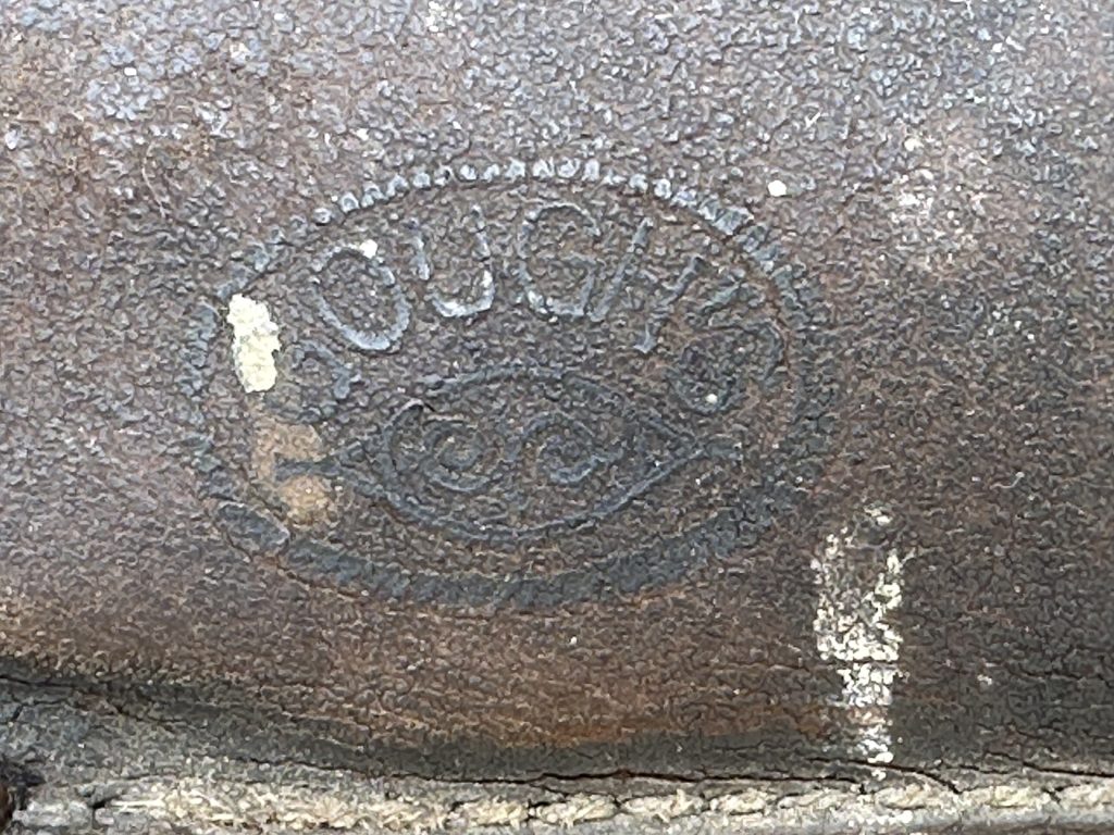 maker name stamped into vintage trike saddle close up