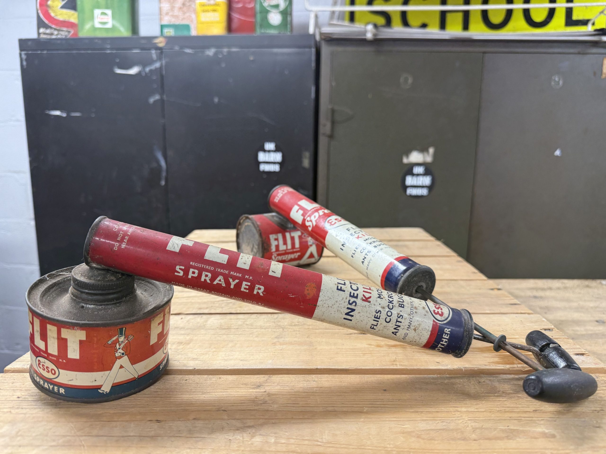Two vintage British-made Esso FLIT insecticide sprayers with original red, cream and blue branding.